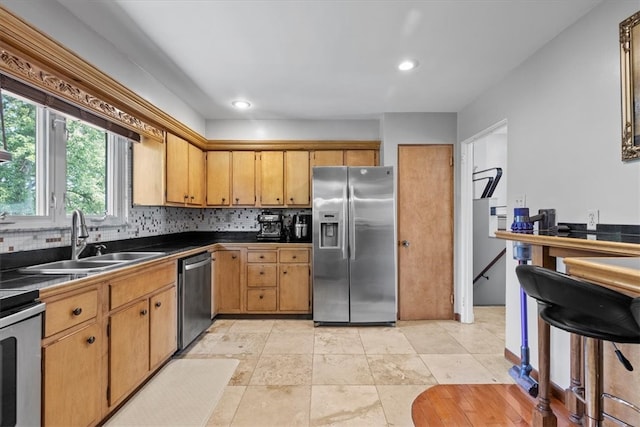 kitchen featuring decorative backsplash, sink, light tile patterned flooring, and appliances with stainless steel finishes