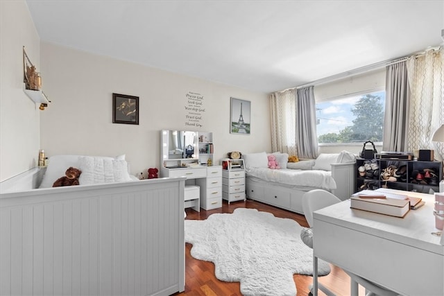 bedroom with dark hardwood / wood-style floors