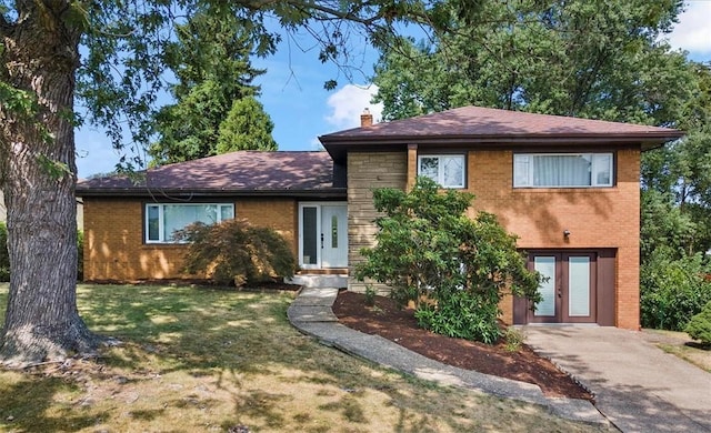 tri-level home with french doors and a front yard