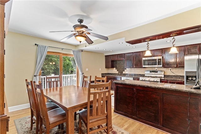 dining space with ceiling fan and light wood-type flooring