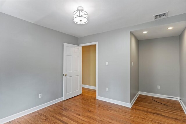 empty room with wood-type flooring