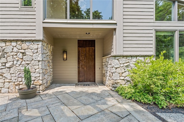 view of exterior entry featuring a patio