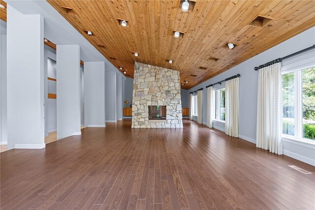 unfurnished living room with a fireplace, wooden ceiling, wood-type flooring, and a healthy amount of sunlight