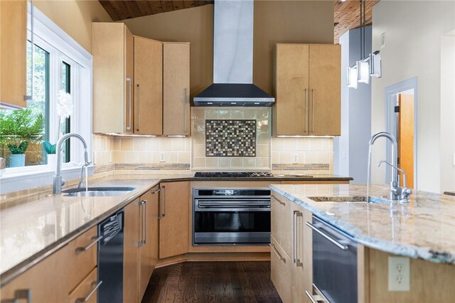 kitchen featuring stainless steel appliances, wall chimney range hood, sink, backsplash, and dark hardwood / wood-style flooring