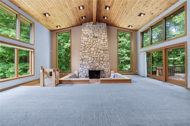 unfurnished living room with a fireplace, light carpet, wood ceiling, and high vaulted ceiling