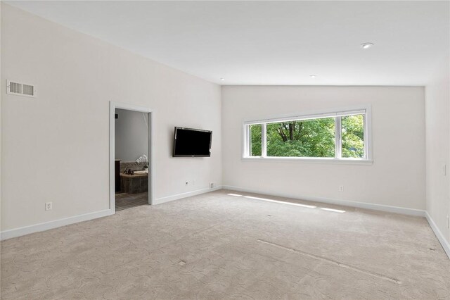 unfurnished living room featuring lofted ceiling and light colored carpet