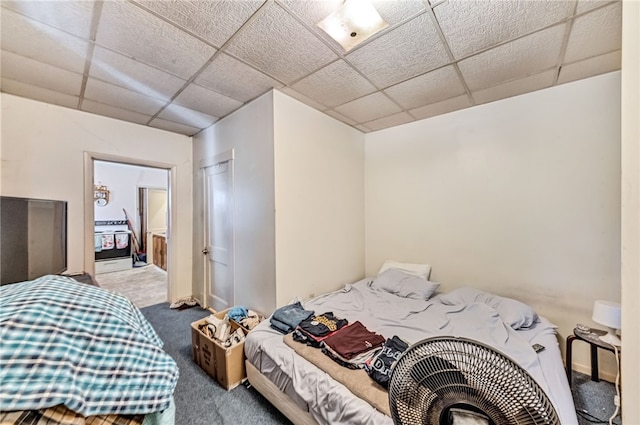 carpeted bedroom featuring a paneled ceiling