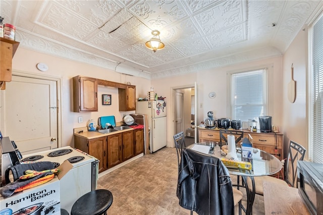 kitchen featuring white appliances and sink