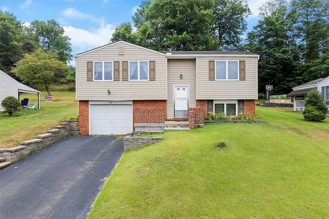 bi-level home featuring a garage and a front lawn