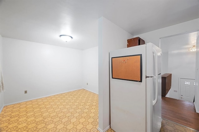 kitchen with white fridge and light tile patterned flooring