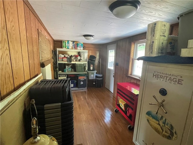home office with wood walls and wood finished floors