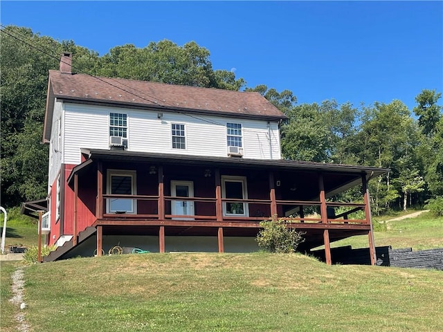 back of house with a lawn and a chimney