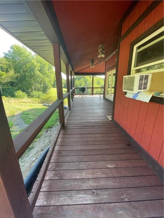 wooden terrace with cooling unit and french doors