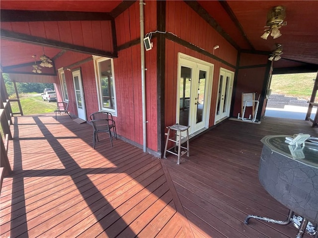 wooden deck with a ceiling fan and french doors