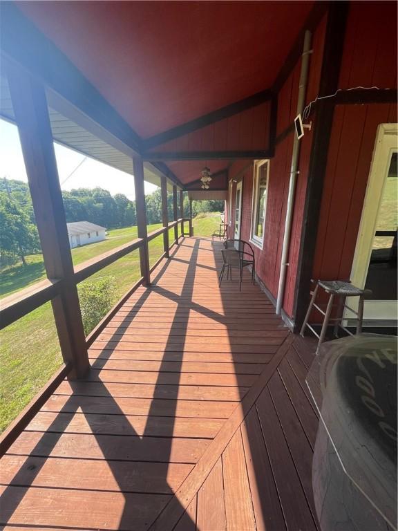 wooden terrace featuring ceiling fan
