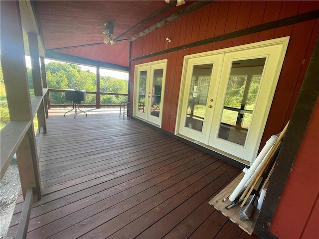 wooden terrace featuring covered porch and french doors