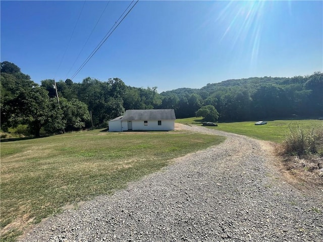 exterior space with a view of trees and a rural view
