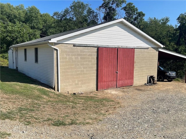 view of outbuilding with a carport and an outdoor structure