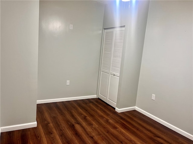 unfurnished bedroom featuring a closet and wood-type flooring