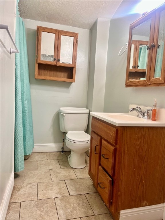 bathroom featuring vanity, toilet, a textured ceiling, and tile patterned flooring