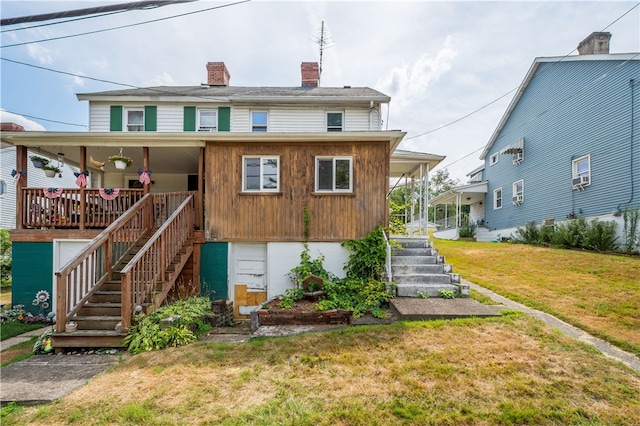 rear view of property with a lawn