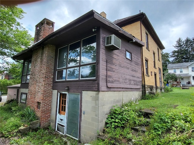 view of property exterior with a lawn