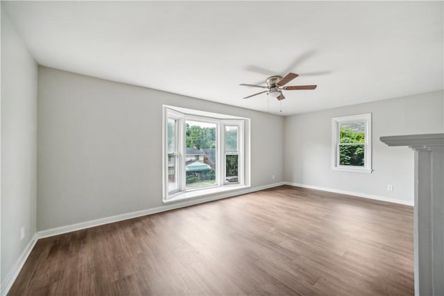 empty room with ceiling fan and hardwood / wood-style floors