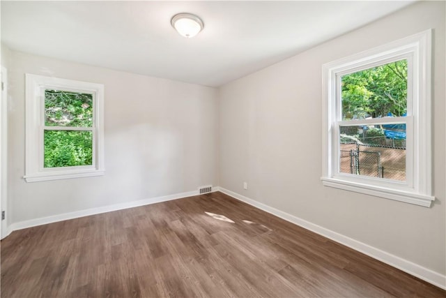 empty room with dark hardwood / wood-style floors