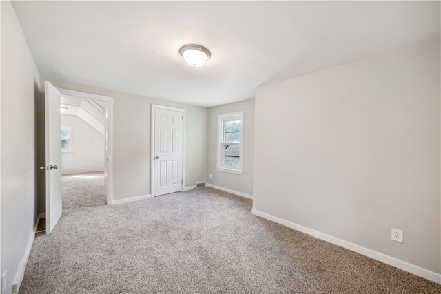 unfurnished bedroom with light colored carpet