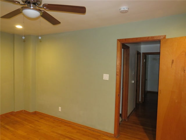 unfurnished room featuring ceiling fan and wood-type flooring