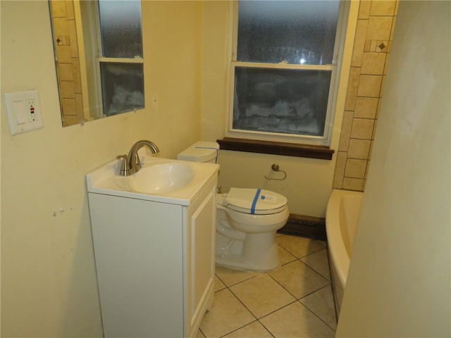 bathroom with a tub to relax in, vanity, toilet, and tile patterned flooring