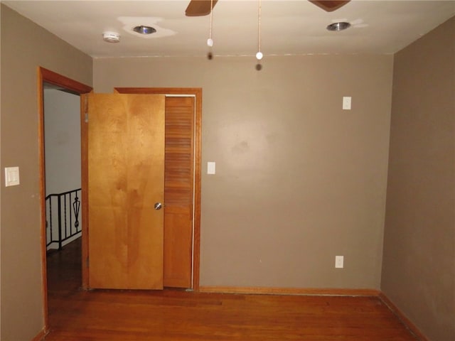 unfurnished room with ceiling fan and hardwood / wood-style flooring