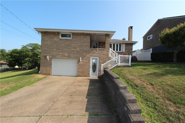 back of house featuring a lawn and a garage