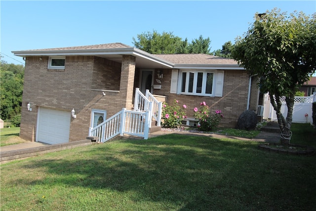 view of front of home with a front yard and a garage