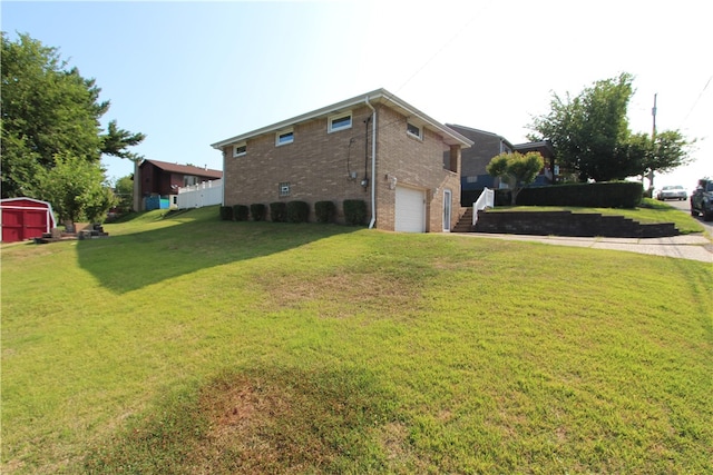 view of side of home with a yard and a garage