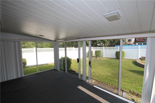 unfurnished sunroom with a healthy amount of sunlight and lofted ceiling