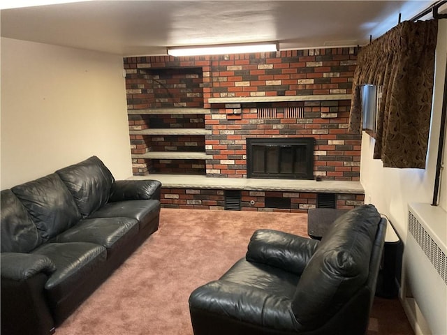 living room with a brick fireplace, radiator heating unit, and carpet floors