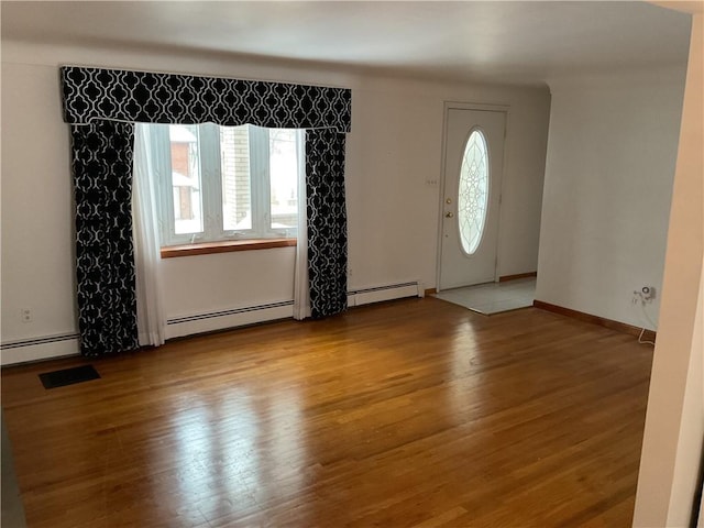 entryway with a baseboard heating unit and light hardwood / wood-style floors