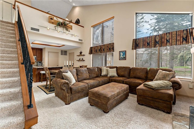 M1 Sunridge Rd, Seven Springs Resort, PA 15622 - living area with light carpet, high vaulted ceiling, and stairway