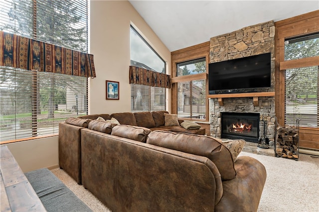 living room featuring high vaulted ceiling, a fireplace, and light carpet