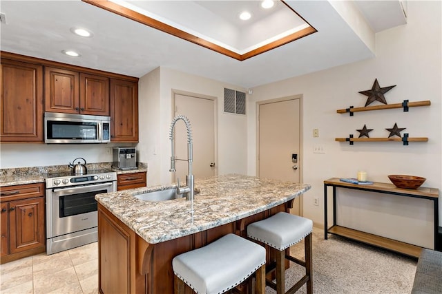 M1 Sunridge Rd, Seven Springs Resort, PA 15622 - kitchen featuring appliances with stainless steel finishes, a sink, light stone countertops, a kitchen bar, and recessed lighting
