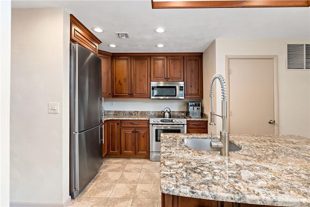 M1 Sunridge Rd, Seven Springs Resort, PA 15622 - kitchen featuring appliances with stainless steel finishes, a sink, light stone countertops, recessed lighting, and brown cabinetry