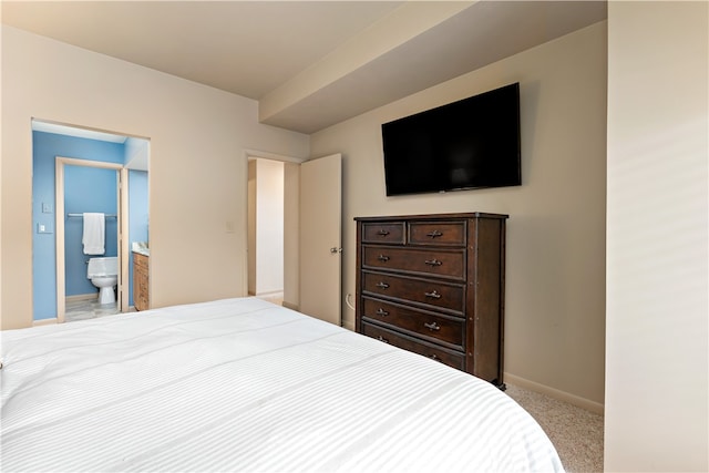 carpeted bedroom featuring connected bathroom