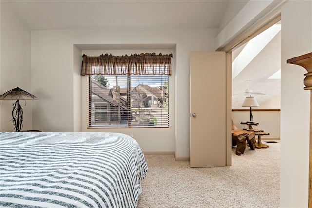 bedroom with carpet flooring and lofted ceiling