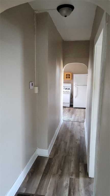 hallway with dark hardwood / wood-style flooring