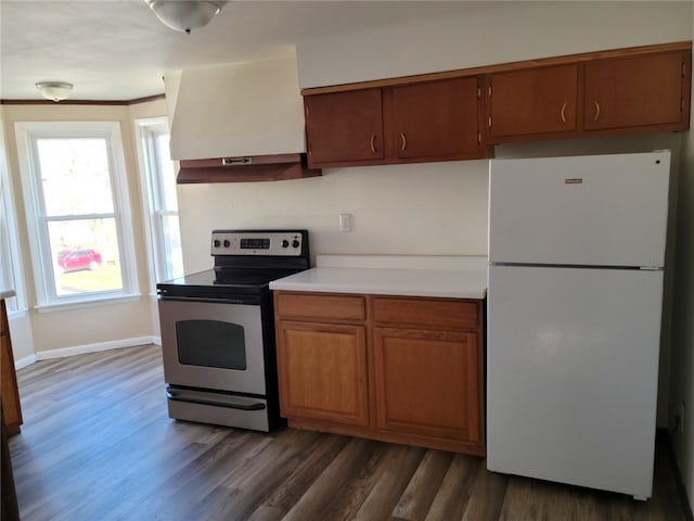 kitchen with exhaust hood, dark wood-type flooring, range with electric cooktop, and white fridge