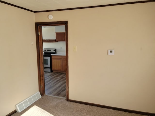 spare room with ornamental molding and light wood-type flooring