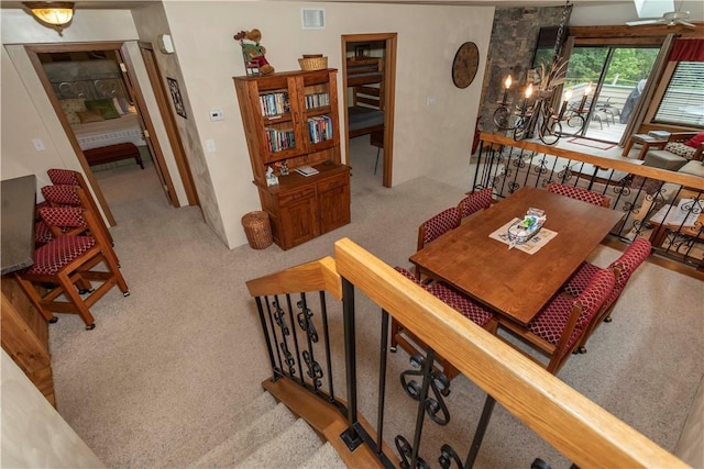 dining room with an inviting chandelier and light carpet