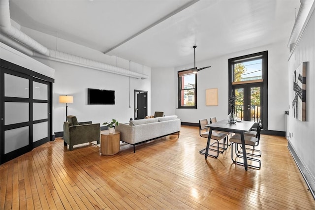 living room featuring light hardwood / wood-style floors, french doors, and ceiling fan