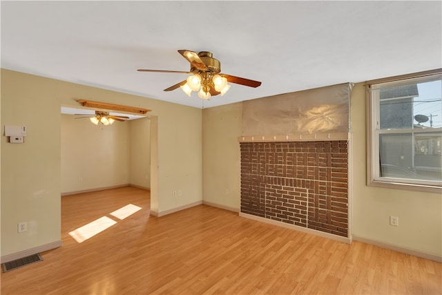 spare room featuring ceiling fan and light wood-type flooring